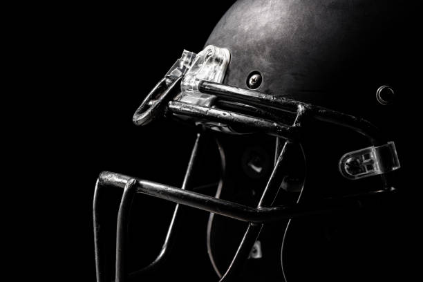 Football helmet on black background.